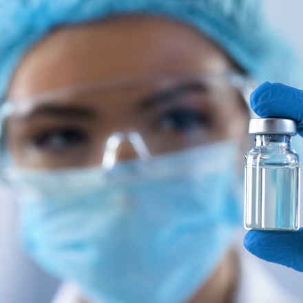 Scientist with drug vial