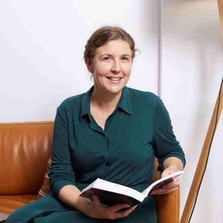 Leah Holroyd smiling with book