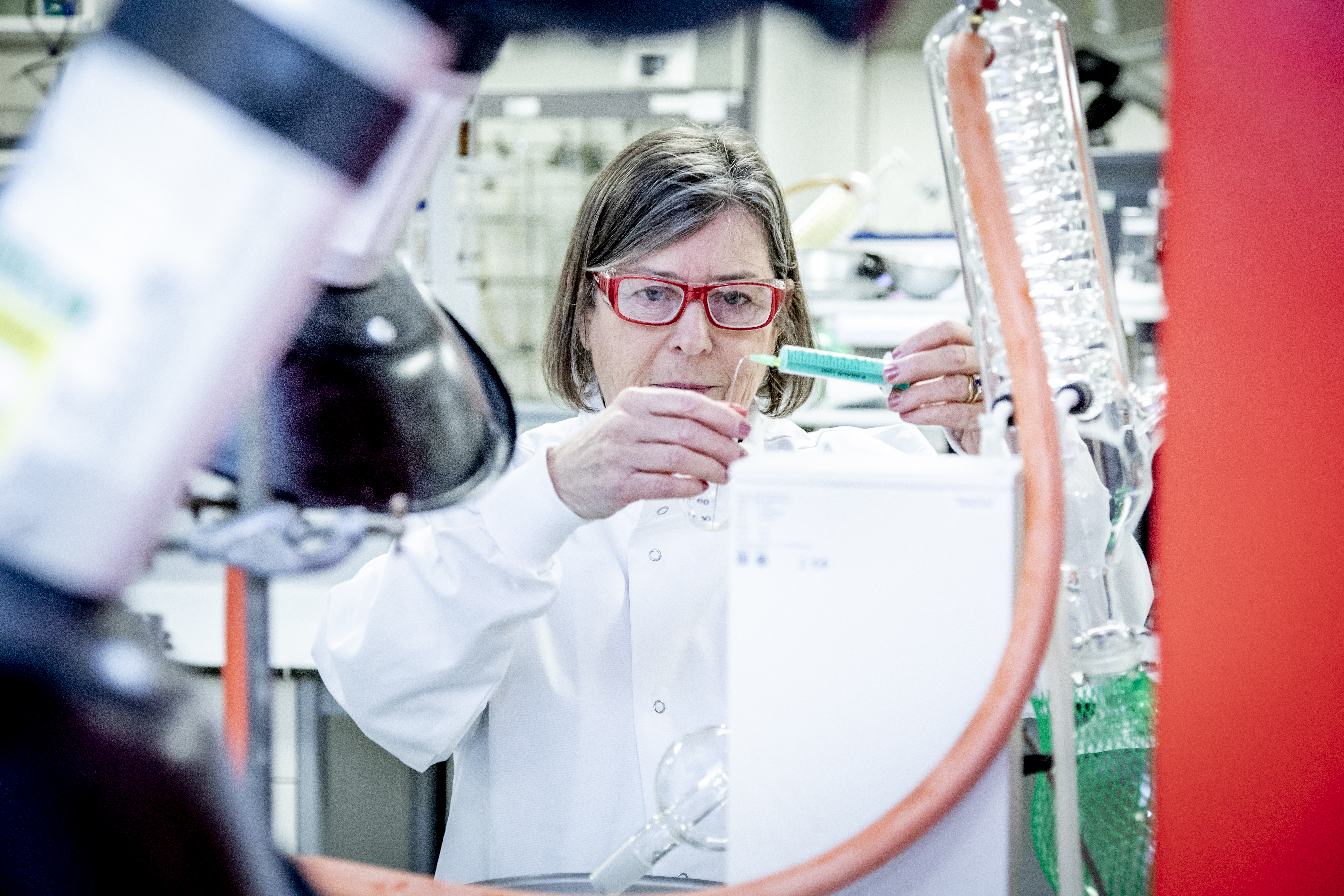 Researcher Dr Mulholland with pipette in the laboratory 