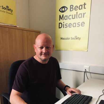 Staff member smiling at desk