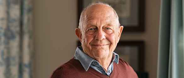 John smiling into the camera