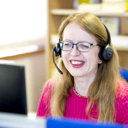 staff member on phone smiling