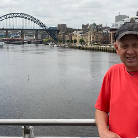 Peter Bennetts standing on bridge over river