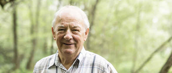 Elderly man smiling outside