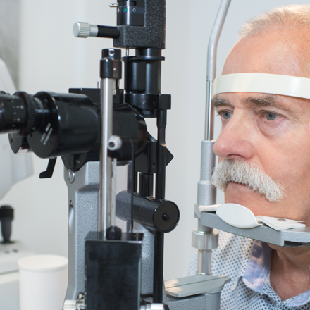 Elderly man having eye scan